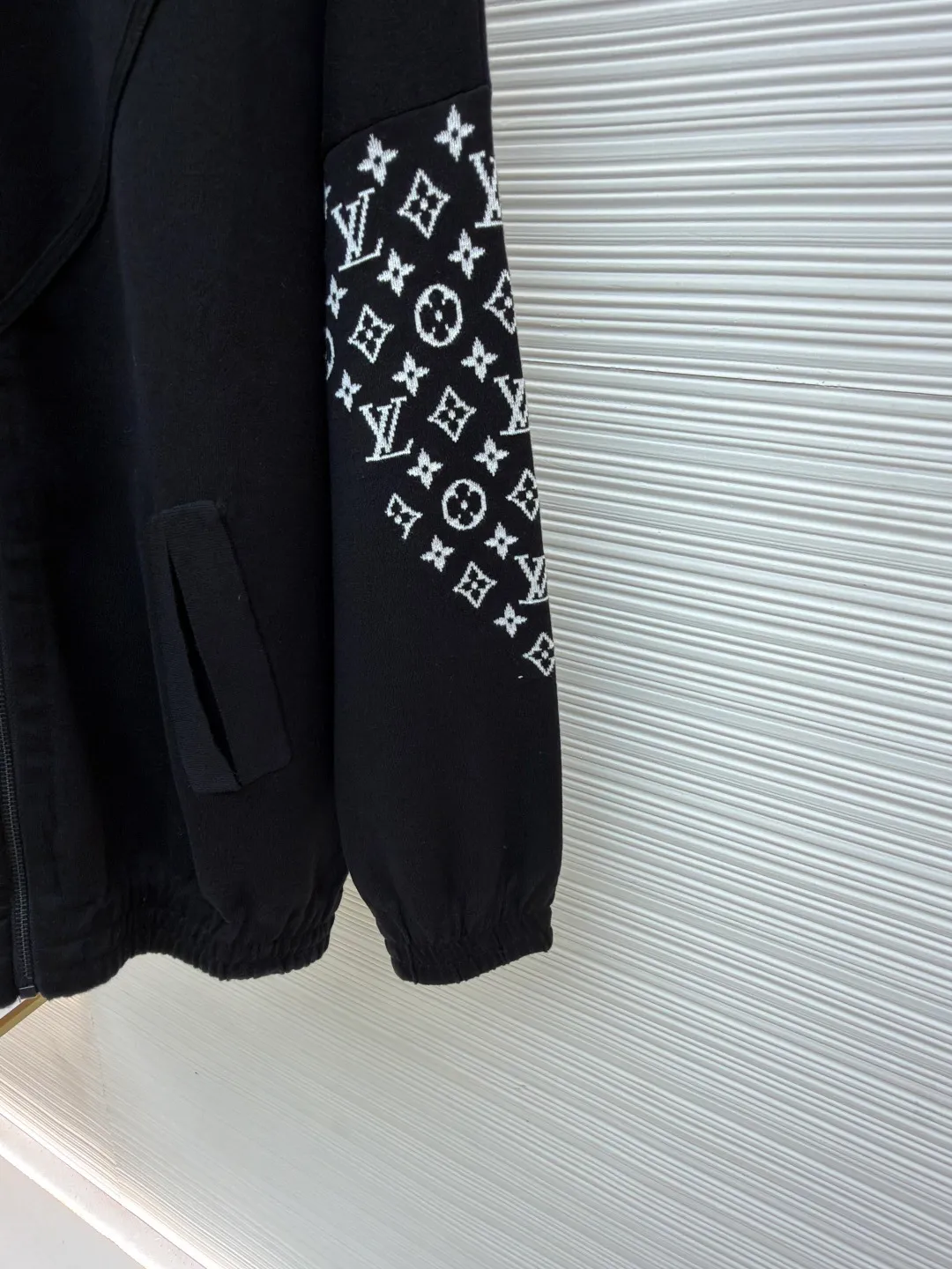 LOUIS VUITTON Monogram element knitted zipper jacket ●Original version: 33000 purchased and developed ●Item number: 1681591-C80 ●Fabric: cotton fabric ●Technology: knitted ●Color: black ●Version: Fitted version ●Weight: about 605 grams ●Size: S-M-L-XL ●Description: This black jacket is made of high-density cotton blended fabric, which feels thick and crisp, and is both soft and wear-resistant. The stand-up collar design and metal zipper are both warm and neat. The classic presbyopia pattern on the sleeves uses fine jacquard technology, and the pattern is three-dimensional and clear, highlighting brand recognition. The body is designed for a loose fit and has a smooth cut for comfort and freedom of movement. There are large pockets on both sides of the front placket, taking into account both practicality and decoration. The inside of the collar and cuffs are double-line reinforced to enhance durability. The brand logo on the chest uses precision embossing technology, and the surface is multi-layered to give it a uniform luster, which contrasts sharply with the black fabric. The inside is neatly hemmed with no excess threads, reflecting the exquisite sewing craftsmanship. The overall design is simple and elegant, with exquisite details. From fabric selection to hardware accessories, every aspect reflects the pursuit of quality. It is an ideal choice for daily wear and outdoor travel. The overall wiring is straight and delicate, the fabric is comfortable and soft, and the color is consistent without color difference. It can be matched with the same style to create a fashionable look and control various occasions. Customized accessories, complete with three standards, same style for men and women!